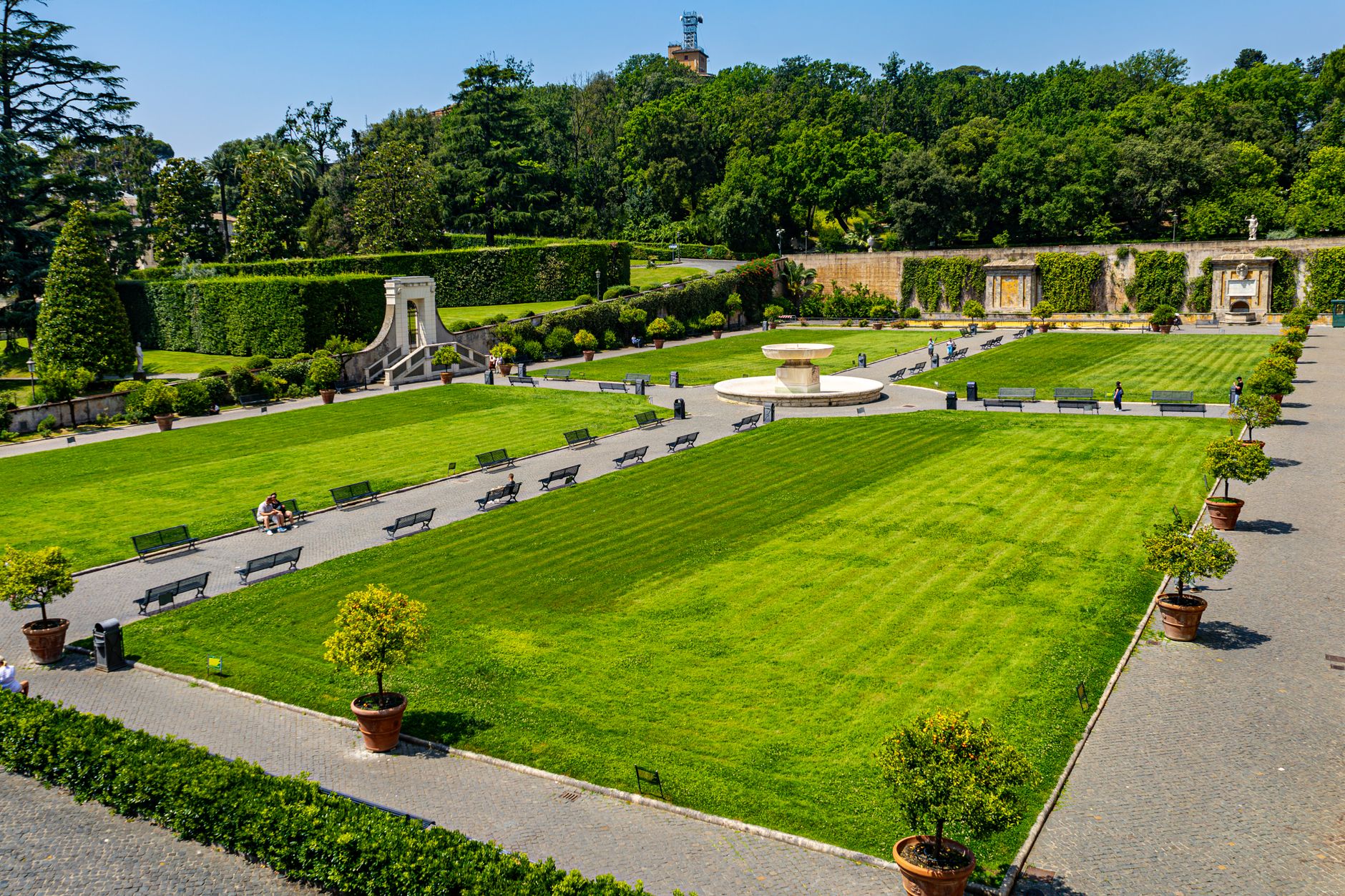 A vibrant view of the Vatican Gardens showcasing lush lawns and elegant architecture.